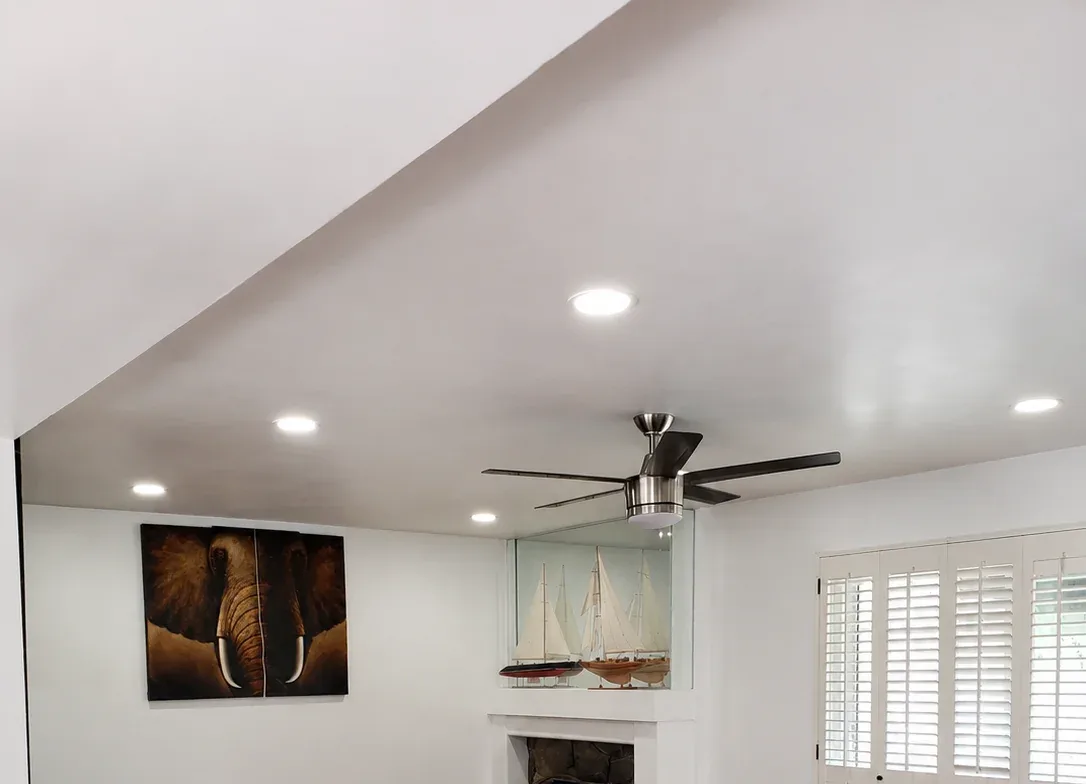 Recessed LED lighting and ceiling fan installation in a remodeled living room