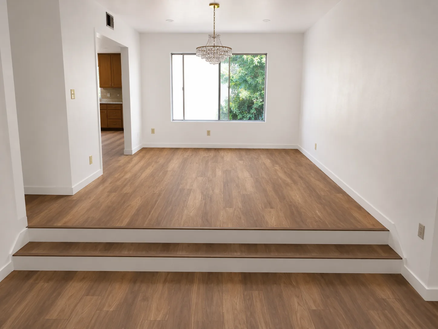 Wood flooring installation across a dining room with a two-step transition